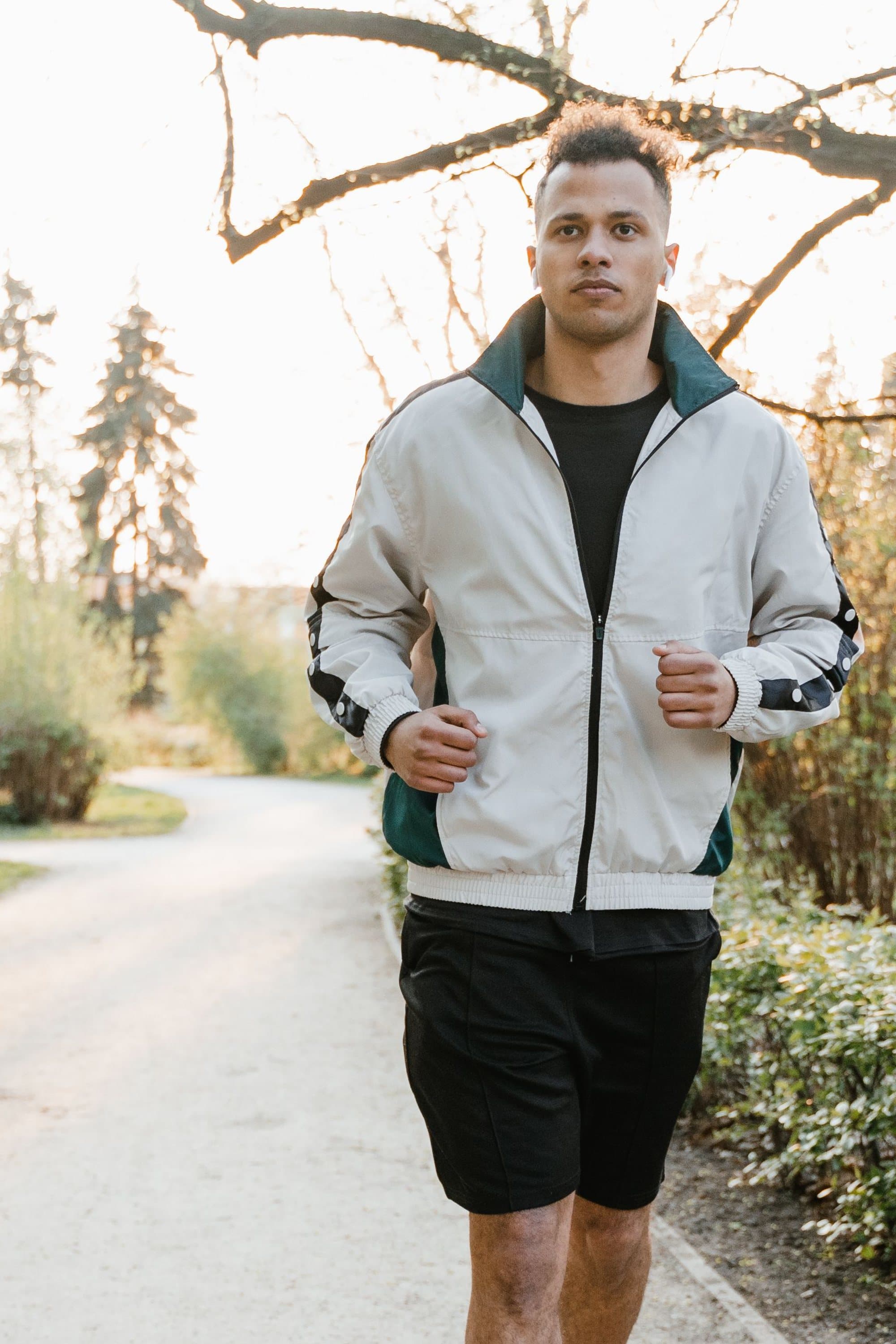 Midsize man jogging through a park